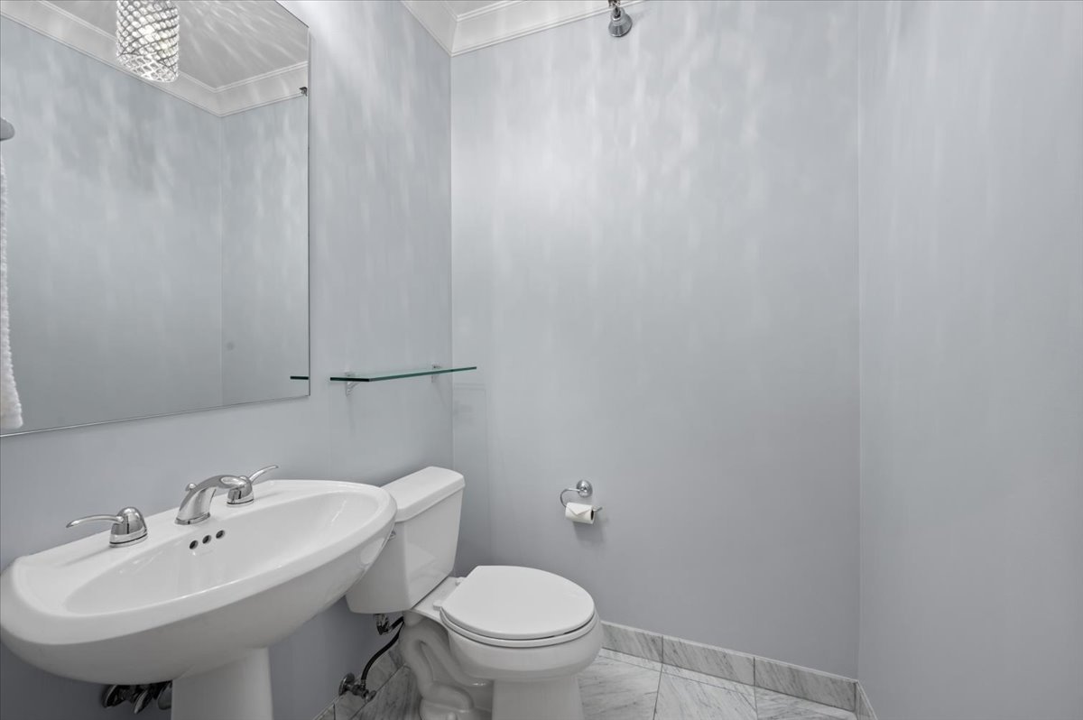 55 East Erie Street, Unit 1903 Chicago, IL 60611 - Photo 30 of 39 a bathroom with a sink a toilet and mirror