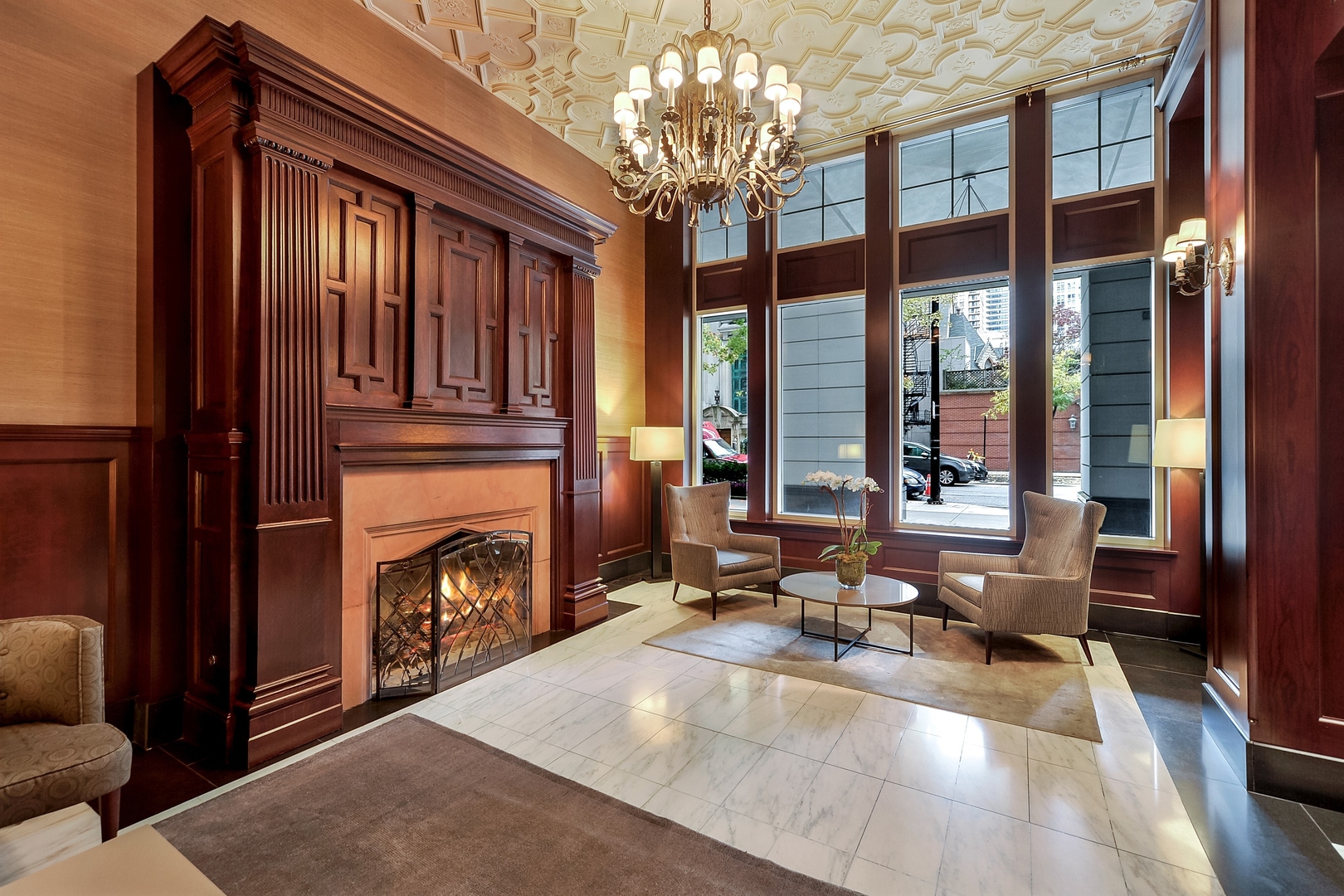 55 East Erie Street, Unit 1903 Chicago, IL 60611 - Photo 36 of 39 a living room with fireplace furniture and a chandelier