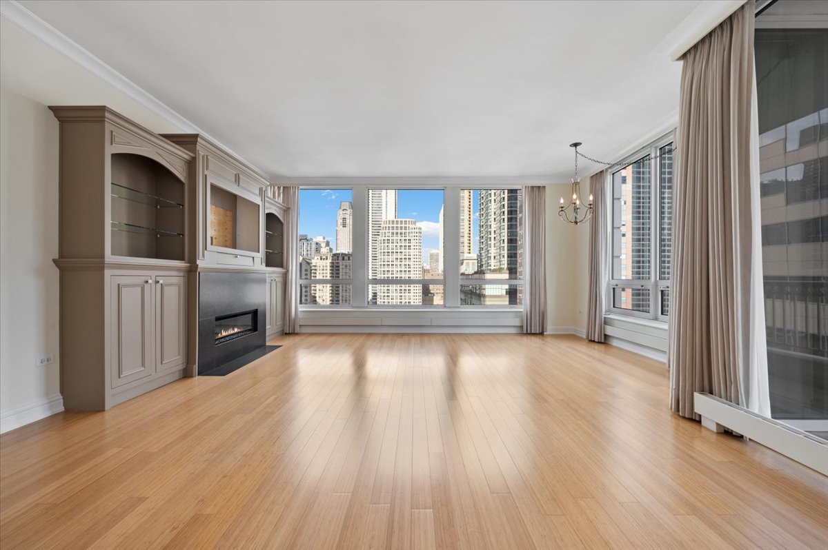 55 East Erie Street, Unit 1903 Chicago, IL 60611 - Photo 7 of 39 a view of a livingroom with wooden floor and a fireplace