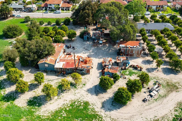 an aerial view of a house with a yard and lake view
