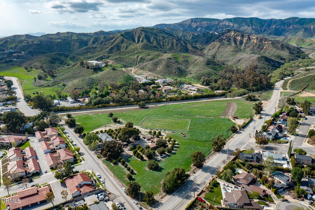 3941 Walnut Avenue Simi Valley, CA 93063 - Photo 4 of 26 an aerial view of a golf course with lots of residential buildings and mountain view in back