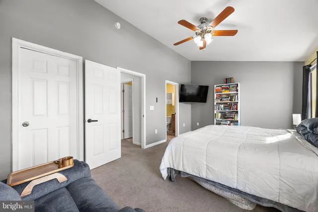 a bedroom with a bed and a flat tv screen