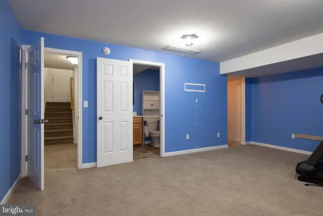 an empty room with closet and mirror