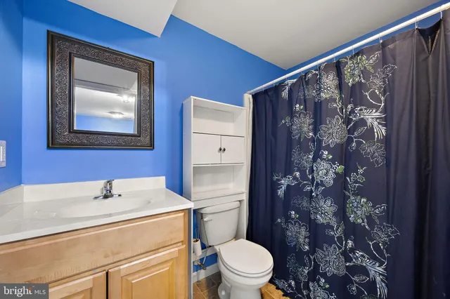a bathroom with a toilet sink and shower