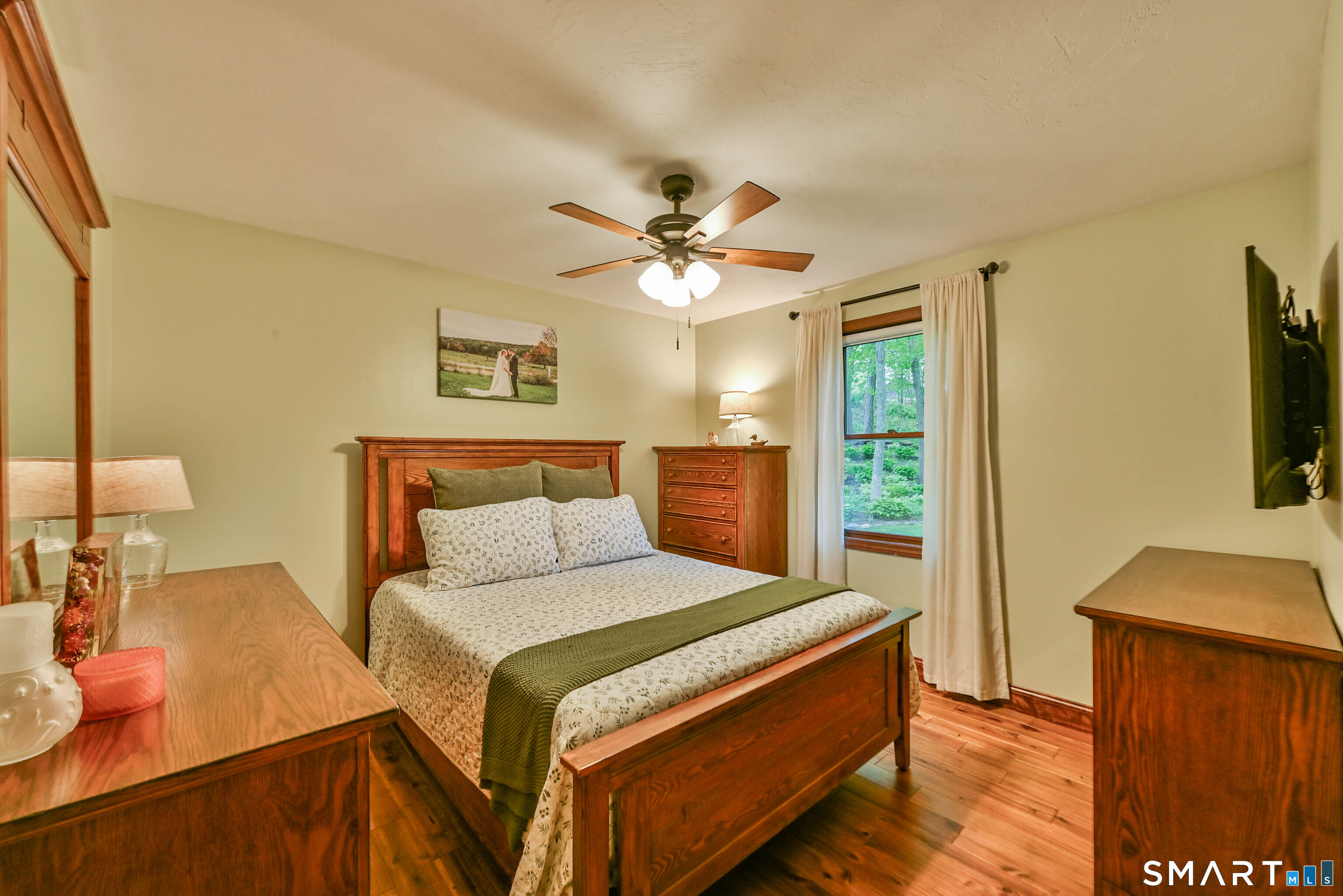309 O'Leary Road Thompson, CT 06277 - Photo 29 of 40 a bedroom with a bed and a flat screen tv