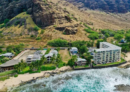 an aerial view of residential houses with yard
