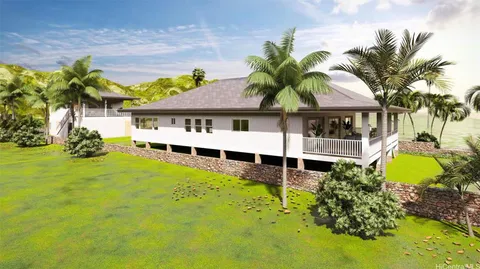 a view of a house with a garden and sitting area