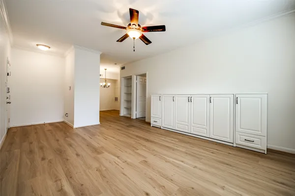 a view of a livingroom with a hardwood floor and a ceiling fan