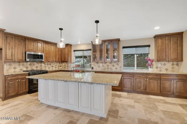 a bathroom with a granite countertop shower and a toilet
