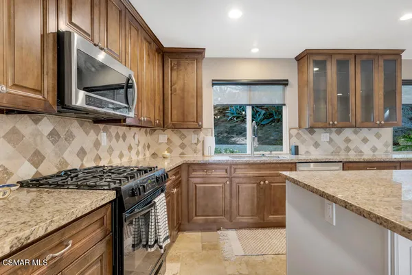a view of staircase with wooden floor and a rug