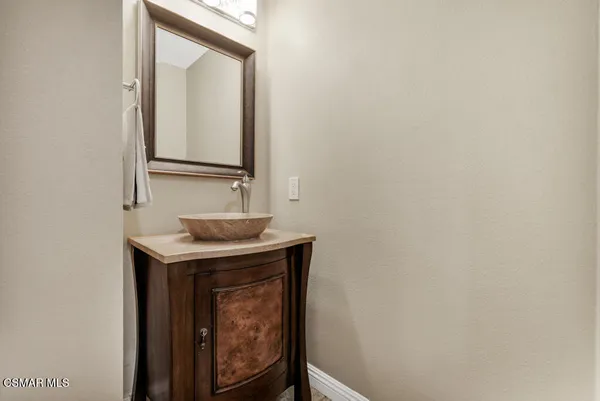 a view of empty room with wooden floor and fireplace