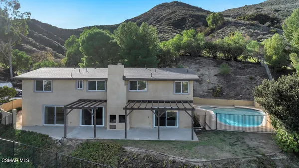 an aerial view of a house with a swimming pool