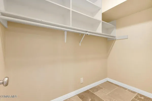 an empty room with wooden floor and a floor to ceiling window