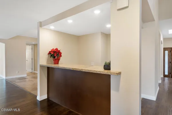 a view of empty room with wooden floor and fireplace