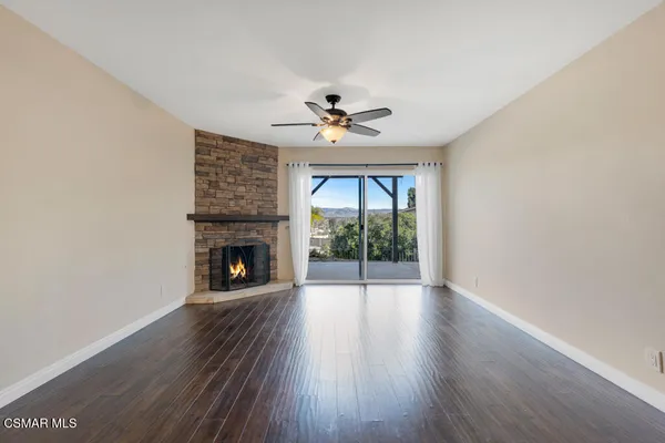 a view of empty room with a fireplace