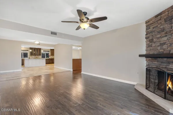 a bathroom with a granite countertop sink a mirror and a bathtub