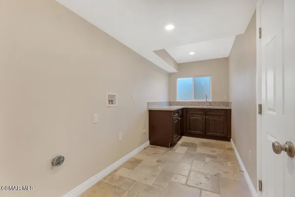a white bath tub sitting in a bathroom next to a window