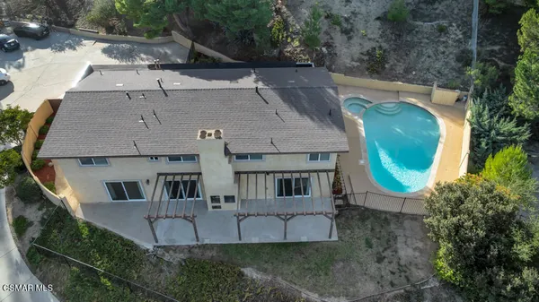 an aerial view of a house with a yard