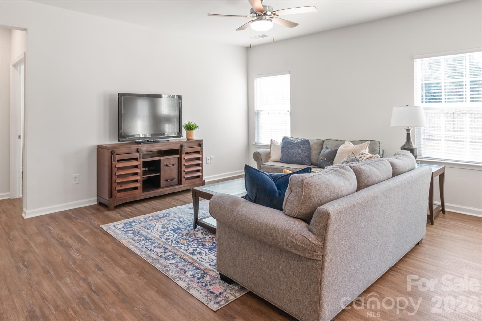1960 Slippery Rock Lane Monroe, NC 28112 - Photo 11 of 32 a living room with furniture and a flat screen tv