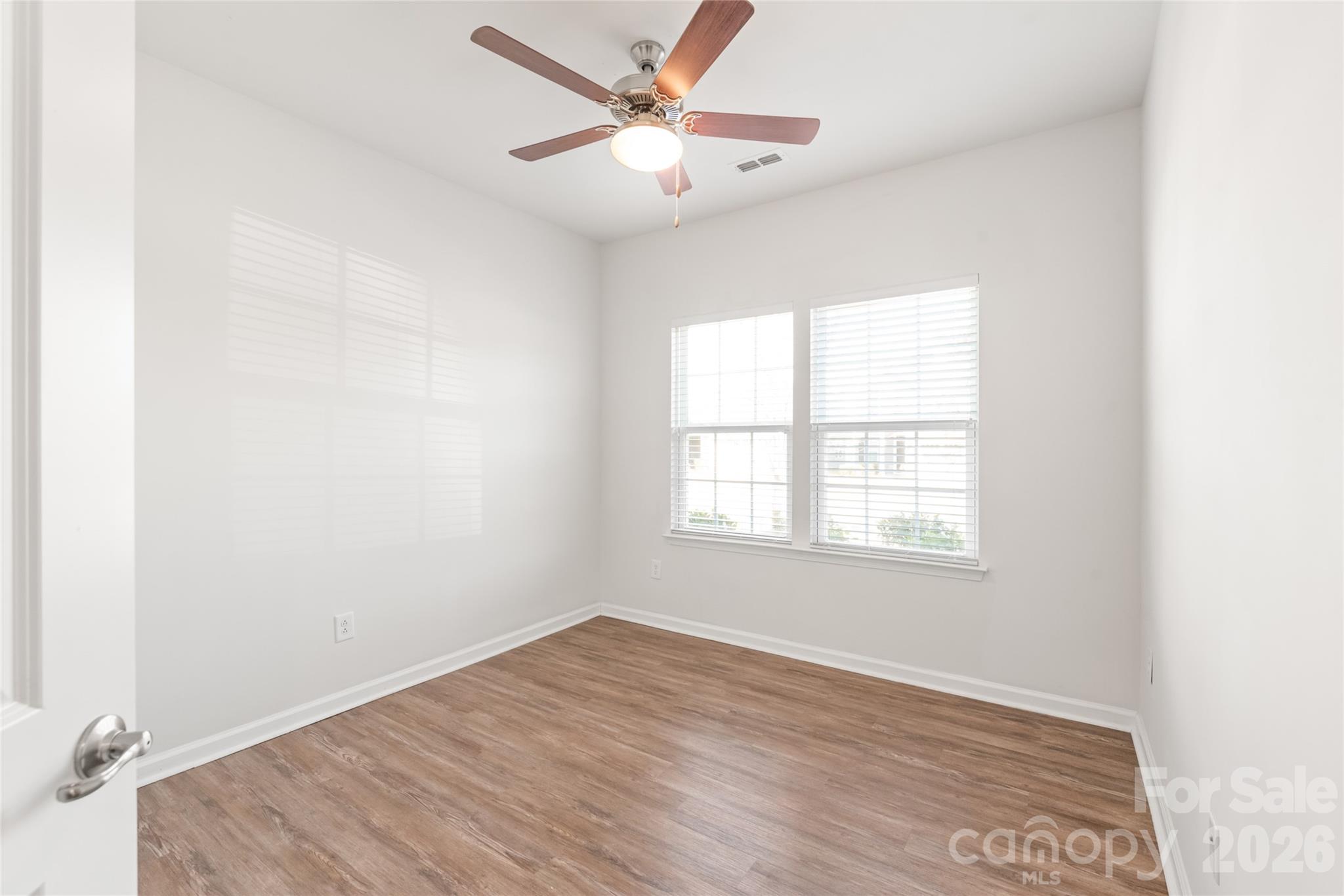 1960 Slippery Rock Lane Monroe, NC 28112 - Photo 22 of 32 an empty room with wooden floor and windows