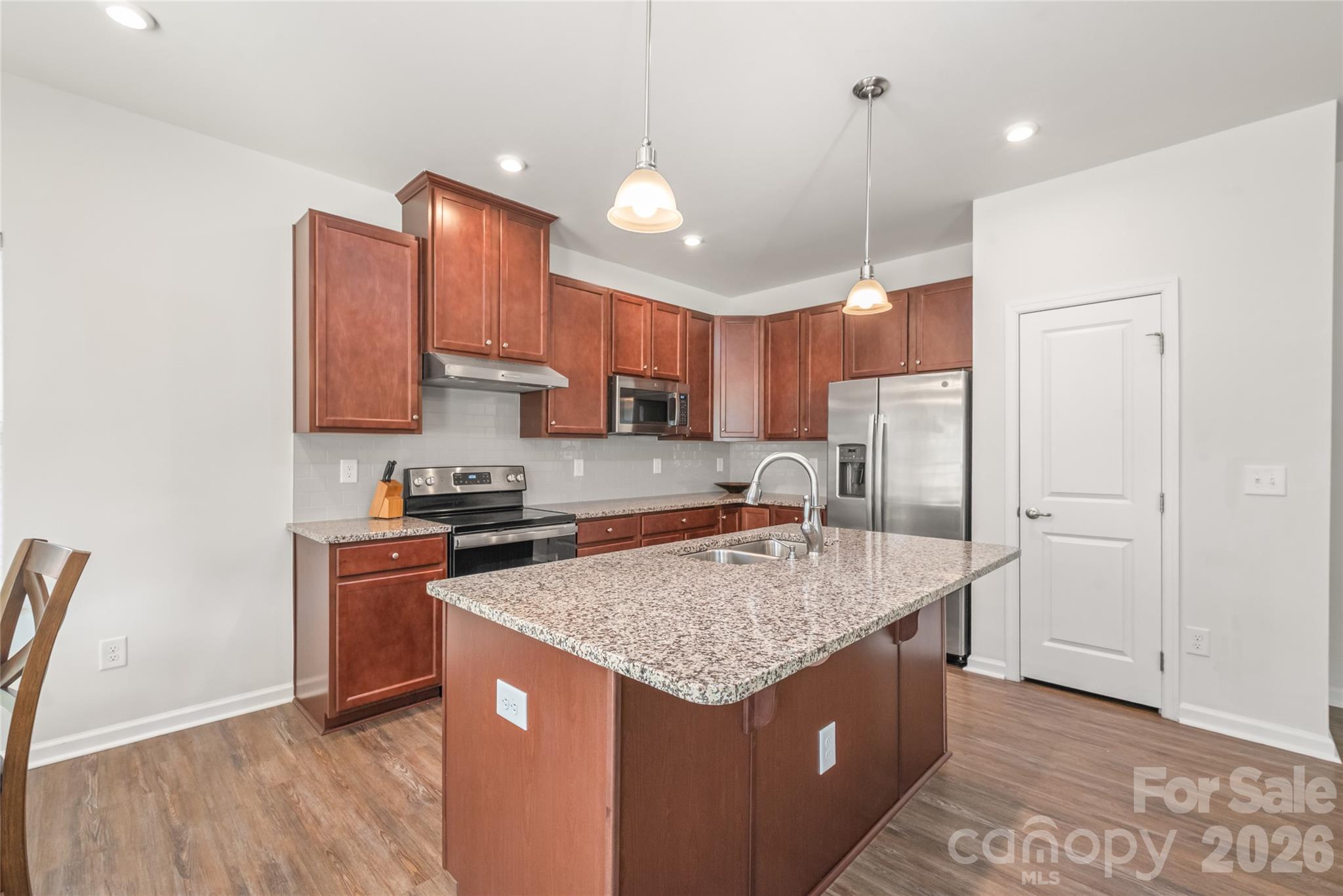 1960 Slippery Rock Lane Monroe, NC 28112 - Photo 7 of 32 a kitchen with stainless steel appliances granite countertop a sink stove and refrigerator