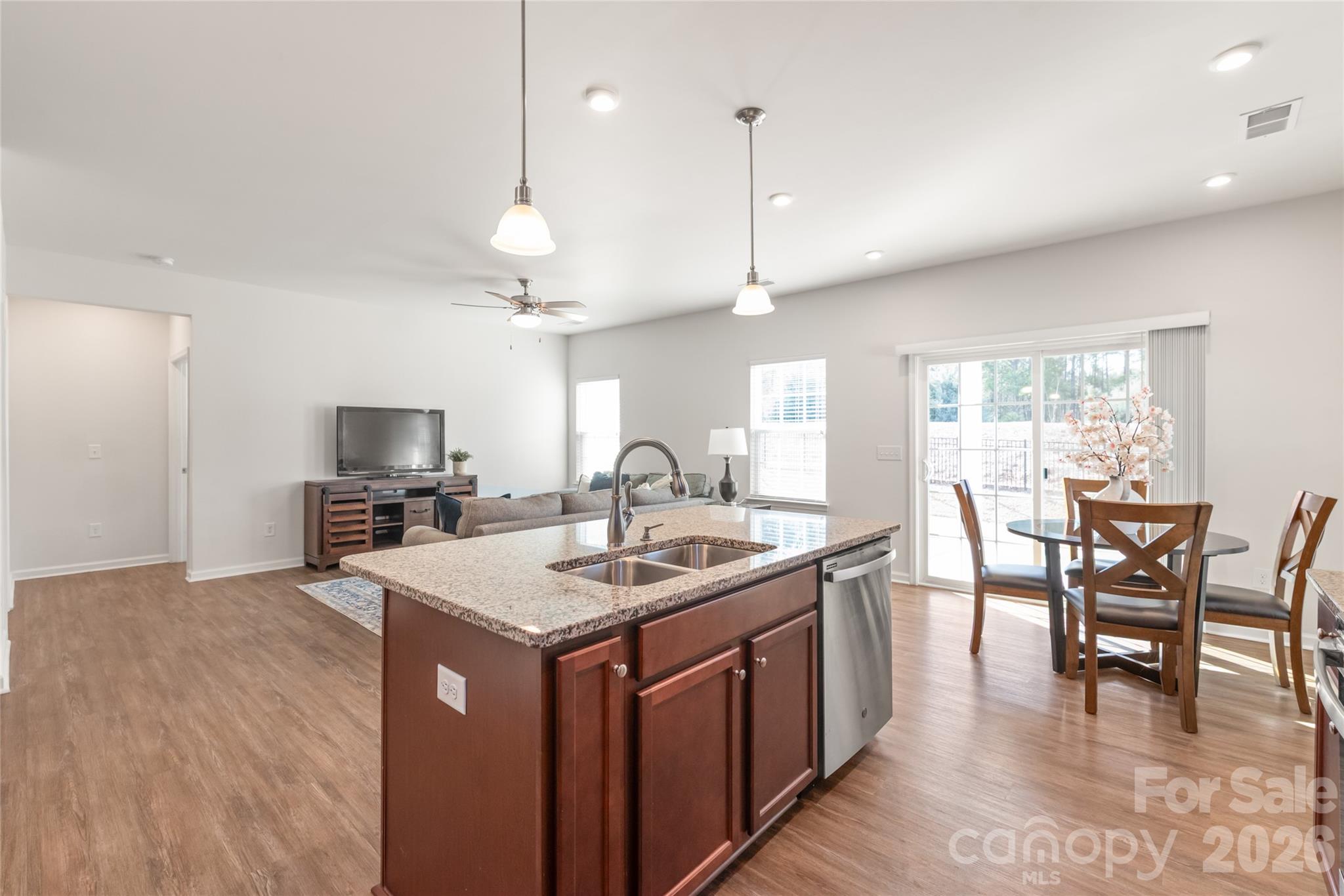 1960 Slippery Rock Lane Monroe, NC 28112 - Photo 9 of 32 a kitchen with a dining table chairs sink and cabinets