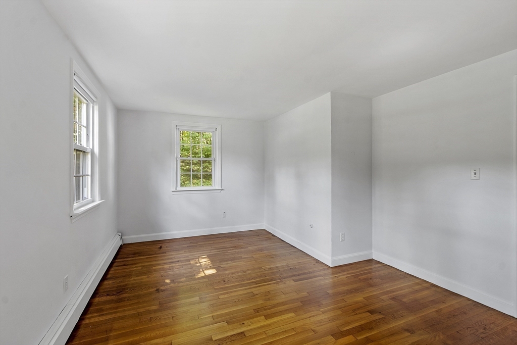 54 Kemp Street Groton, MA 01450 - Photo 13 of 38 a view of empty room with wooden floor and fan