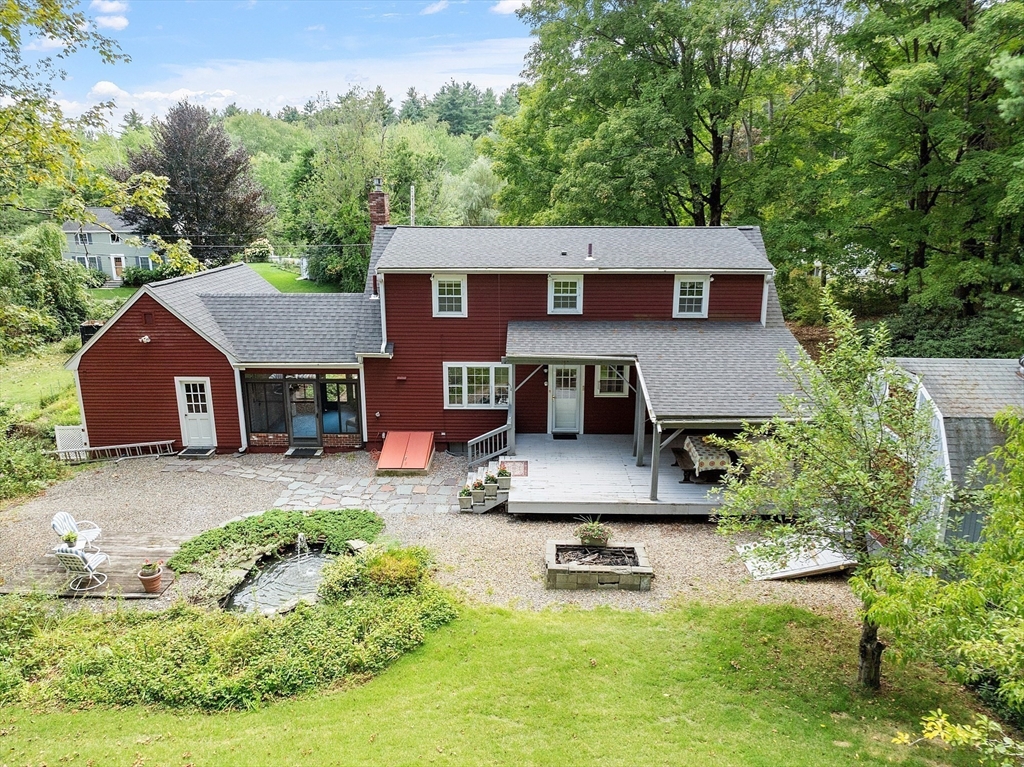 54 Kemp Street Groton, MA 01450 - Photo 3 of 38 a aerial view of a house with swimming pool and a yard