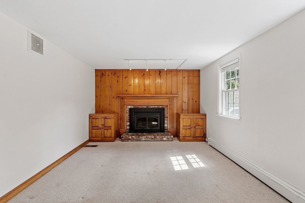 54 Kemp Street Groton, MA 01450 - Photo 8 of 38 a view of empty room with a fireplace