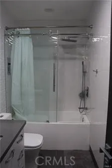 a bathroom with a shower and a sink