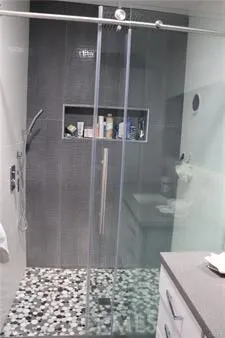 a white toilet sitting next to a shower