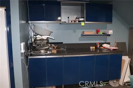 a kitchen with a refrigerator and a stove