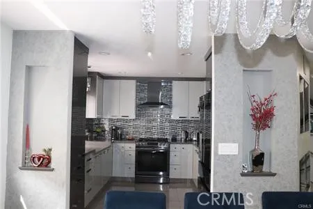 a kitchen with kitchen island granite countertop a sink cabinets and stainless steel appliances