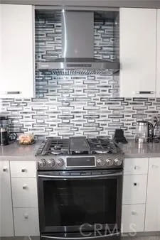a stove top oven sitting inside of a kitchen