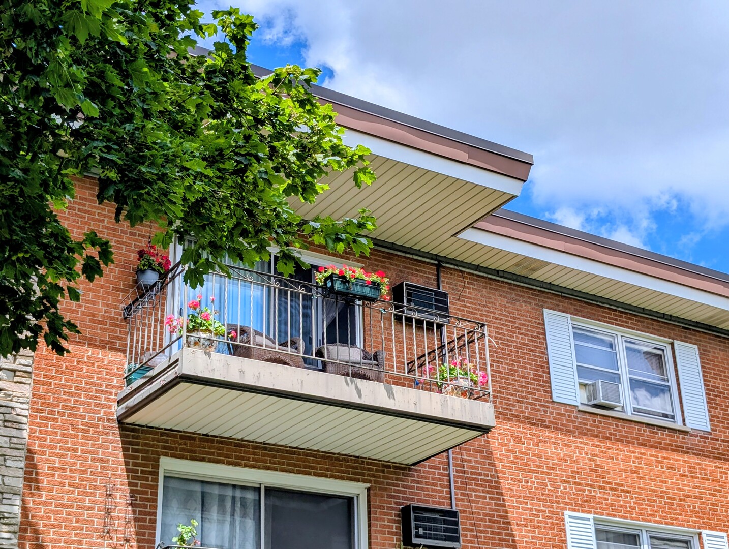 4229 North Keystone Avenue, Unit 3H Chicago, IL 60641 - Photo 3 of 22 a view of a house with a large window and potted plants