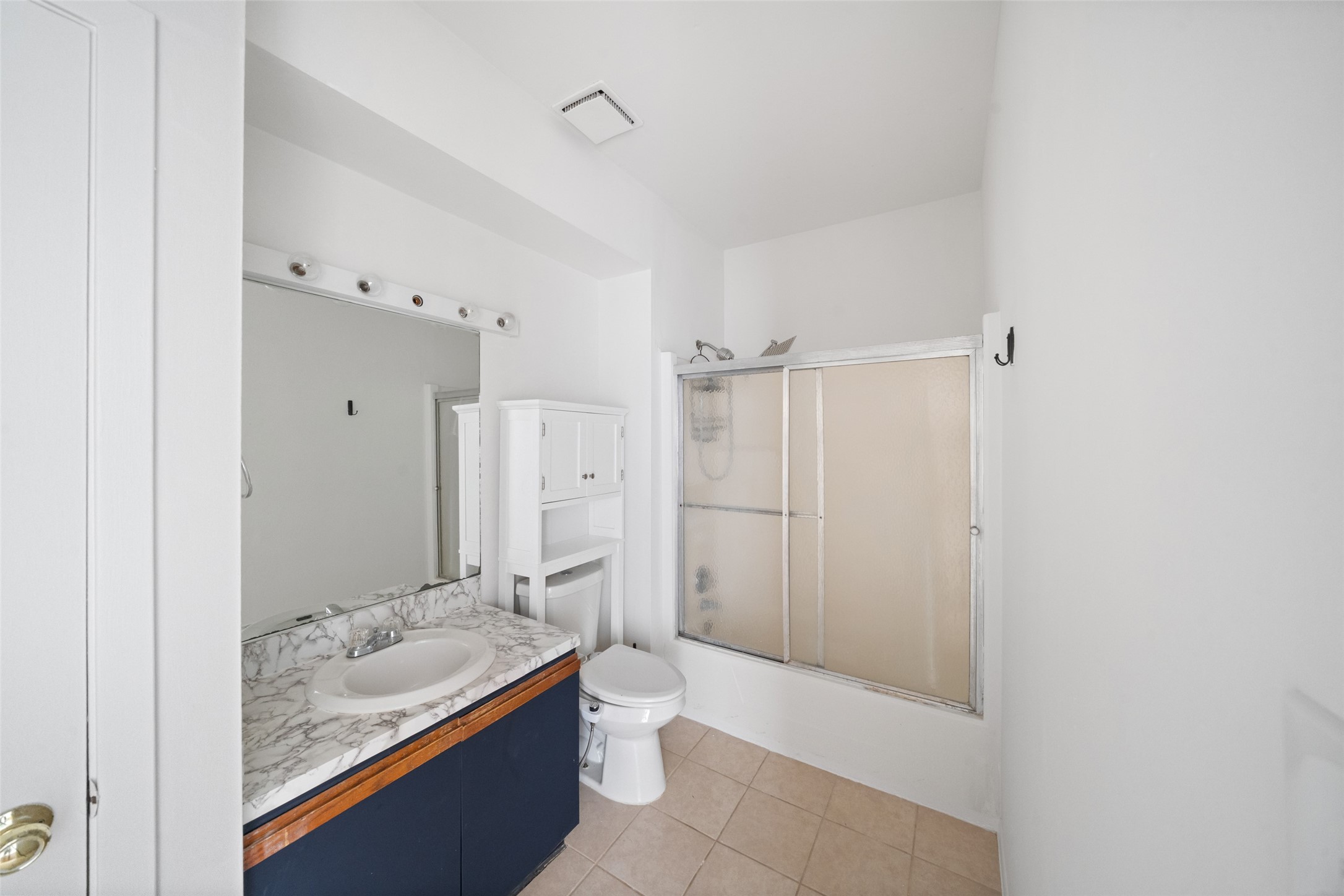 518 Hawthorne Street, Unit 2 Houston, TX 77006 - Photo 12 of 15 a bathroom with a granite countertop sink a toilet and shower