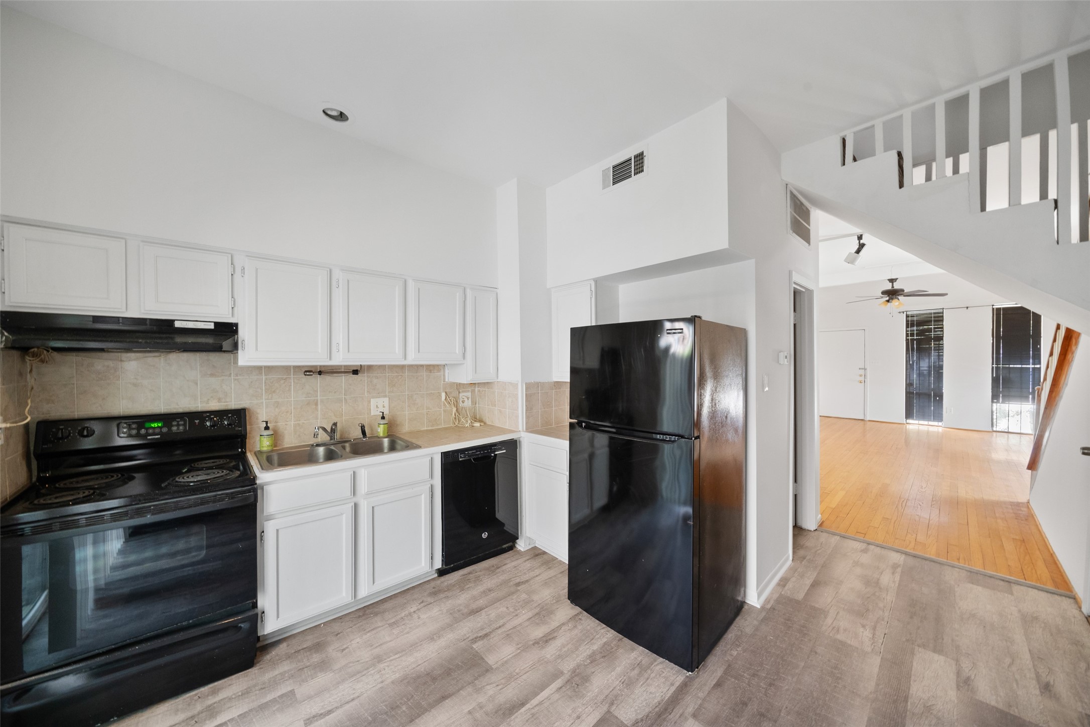 518 Hawthorne Street, Unit 2 Houston, TX 77006 - Photo 9 of 15 a kitchen with a refrigerator stove and wooden cabinets