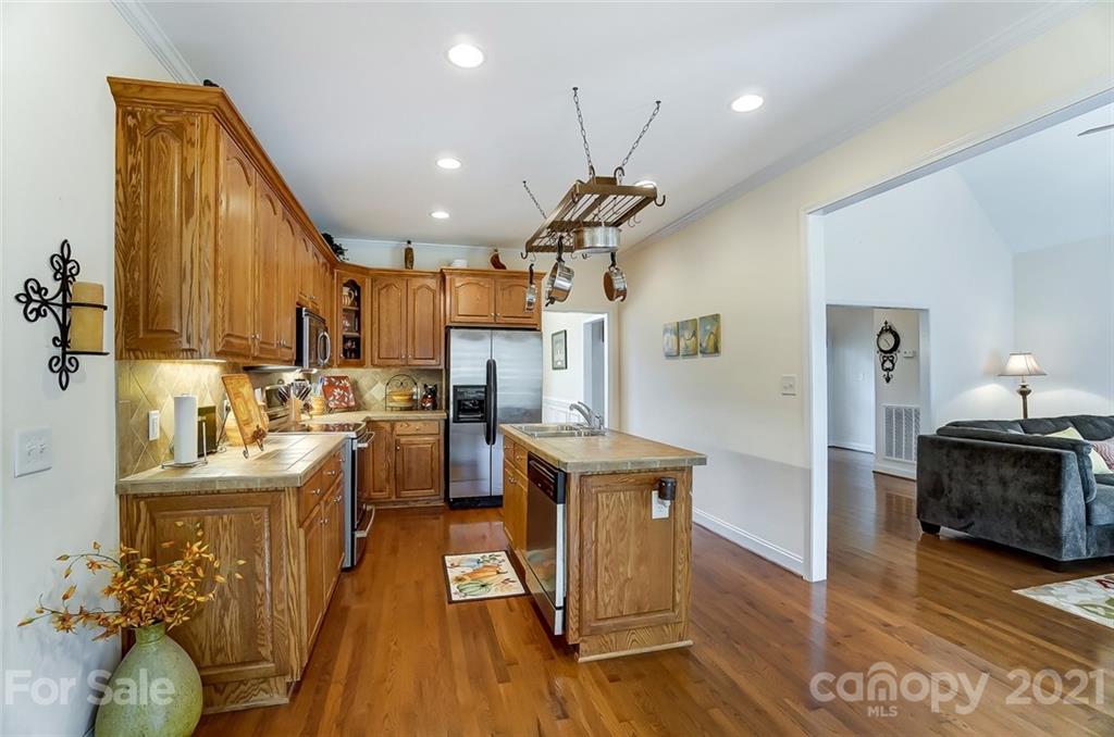 9180 Meadowood Road Mount Pleasant, NC 28124 - Photo 11 of 37 a view of a kitchen and dining room with wooden floor