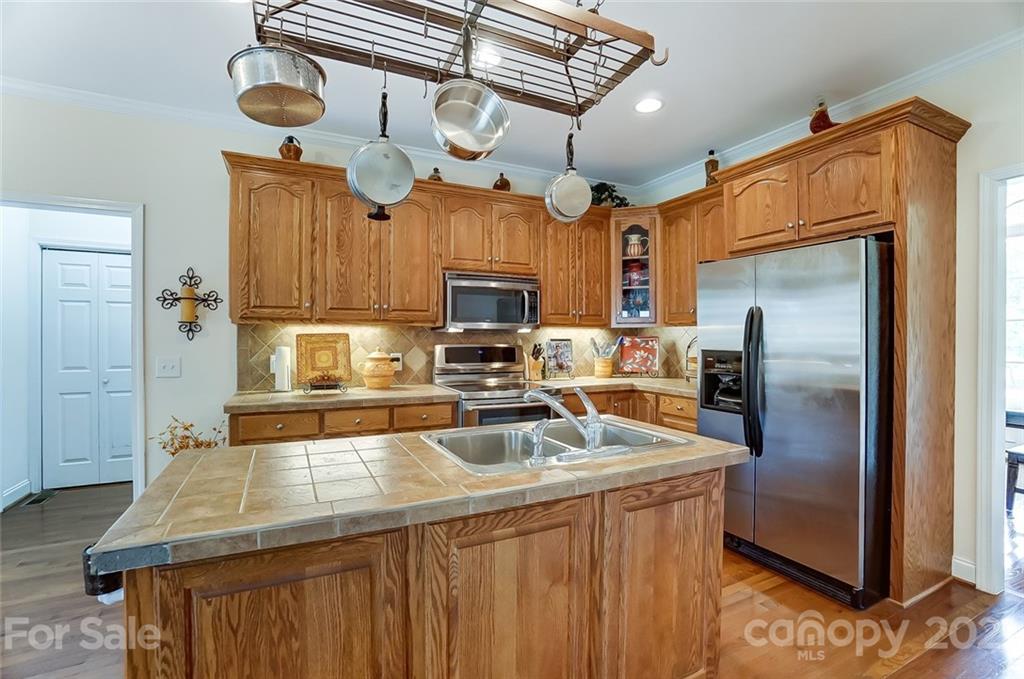 9180 Meadowood Road Mount Pleasant, NC 28124 - Photo 12 of 37 a kitchen with stainless steel appliances granite countertop a sink a refrigerator and a granite counter tops