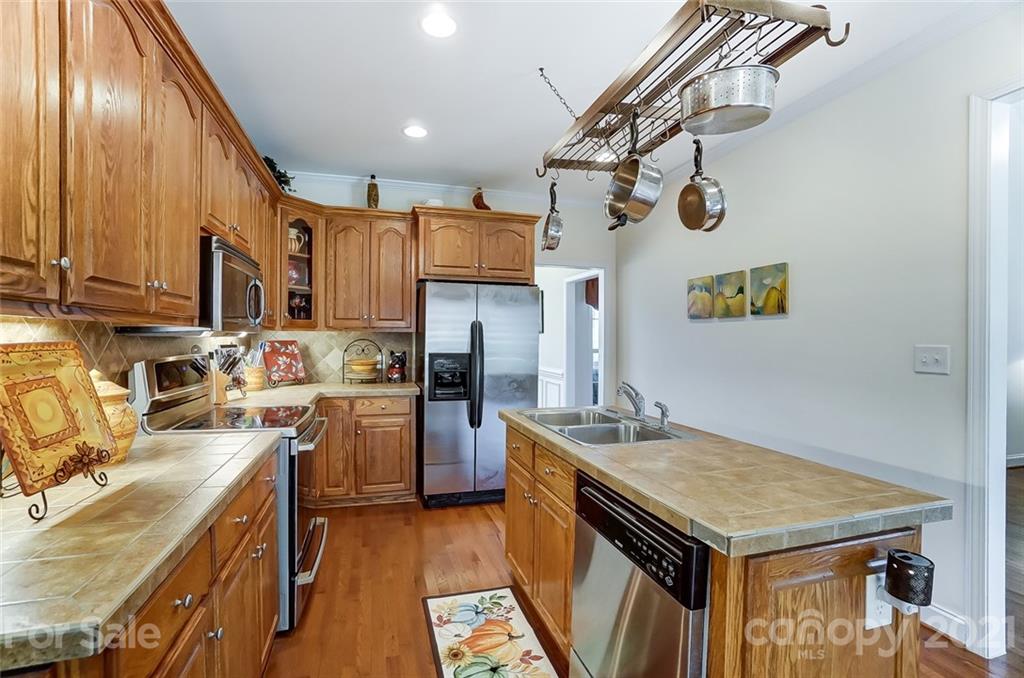 9180 Meadowood Road Mount Pleasant, NC 28124 - Photo 14 of 37 a kitchen with refrigerator a stove and a sink
