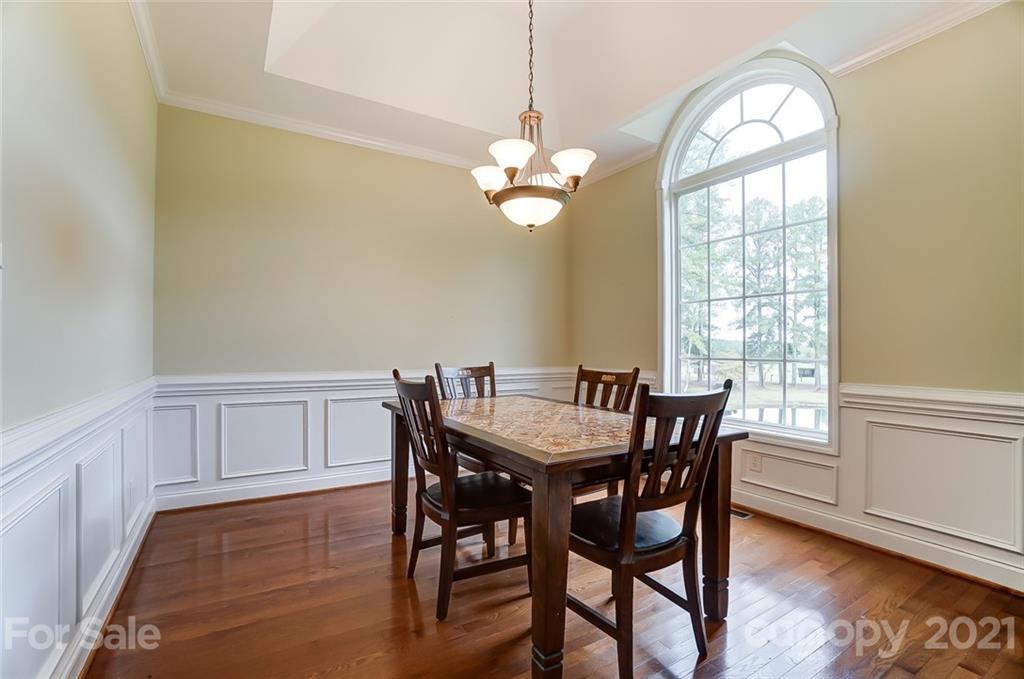 9180 Meadowood Road Mount Pleasant, NC 28124 - Photo 18 of 37 a view of a dining room with furniture window and wooden floor