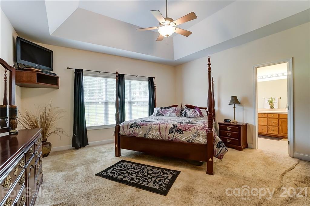 9180 Meadowood Road Mount Pleasant, NC 28124 - Photo 20 of 37 a bedroom with a bed and a walk in closet