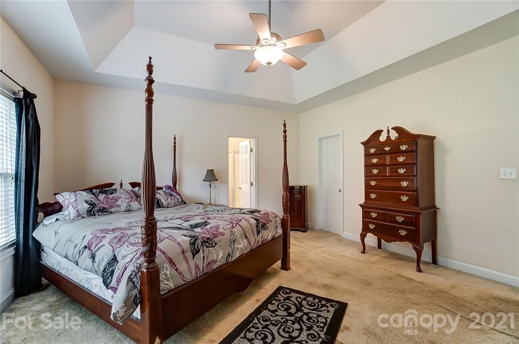 9180 Meadowood Road Mount Pleasant, NC 28124 - Photo 21 of 37 a bedroom with a bed and a walk in closet