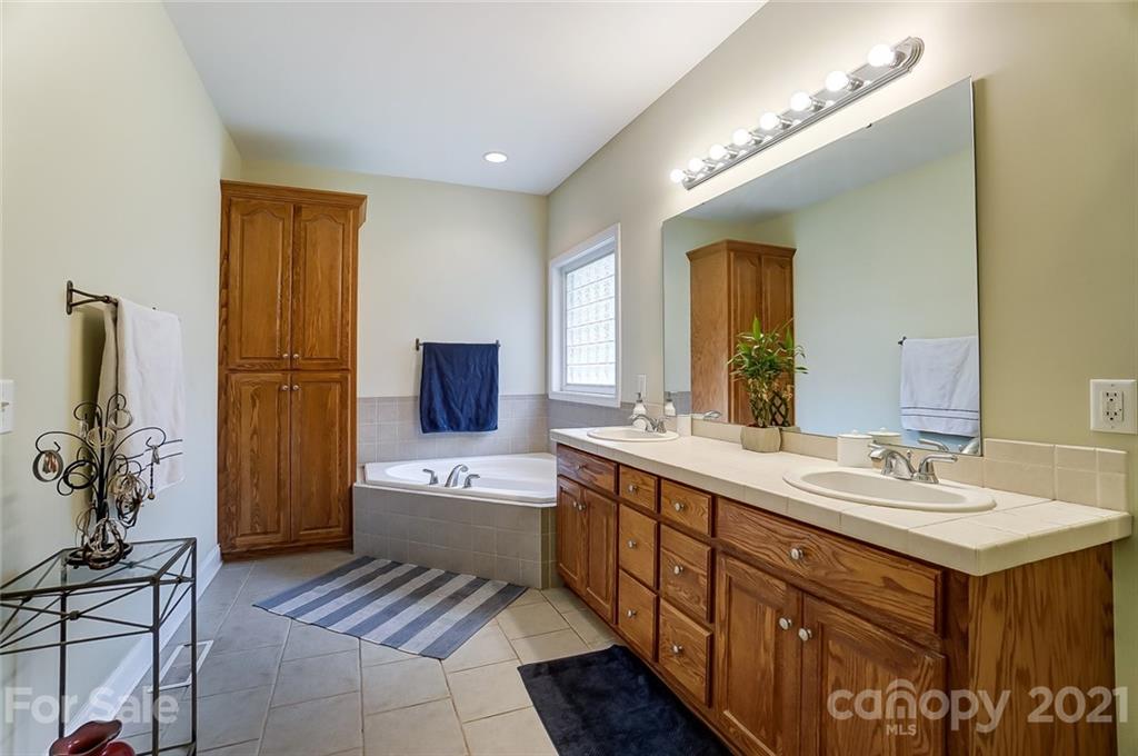 9180 Meadowood Road Mount Pleasant, NC 28124 - Photo 24 of 37 a spacious bathroom with a double vanity sink a mirror and shower