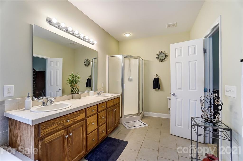 9180 Meadowood Road Mount Pleasant, NC 28124 - Photo 25 of 37 a bathroom with a double vanity sink mirror and shower