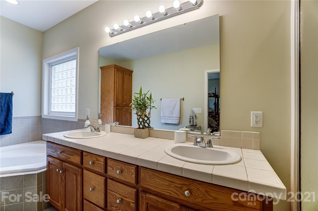 9180 Meadowood Road Mount Pleasant, NC 28124 - Photo 26 of 37 a bathroom with a sink and a mirror