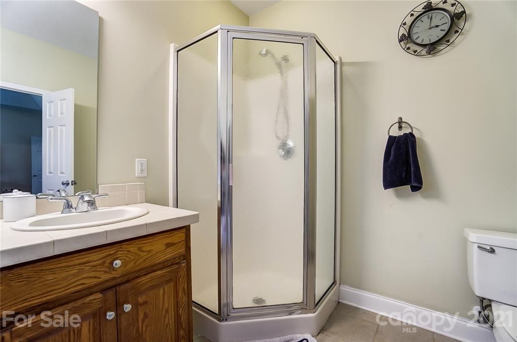 9180 Meadowood Road Mount Pleasant, NC 28124 - Photo 28 of 37 a bathroom with a sink a mirror and a toilet