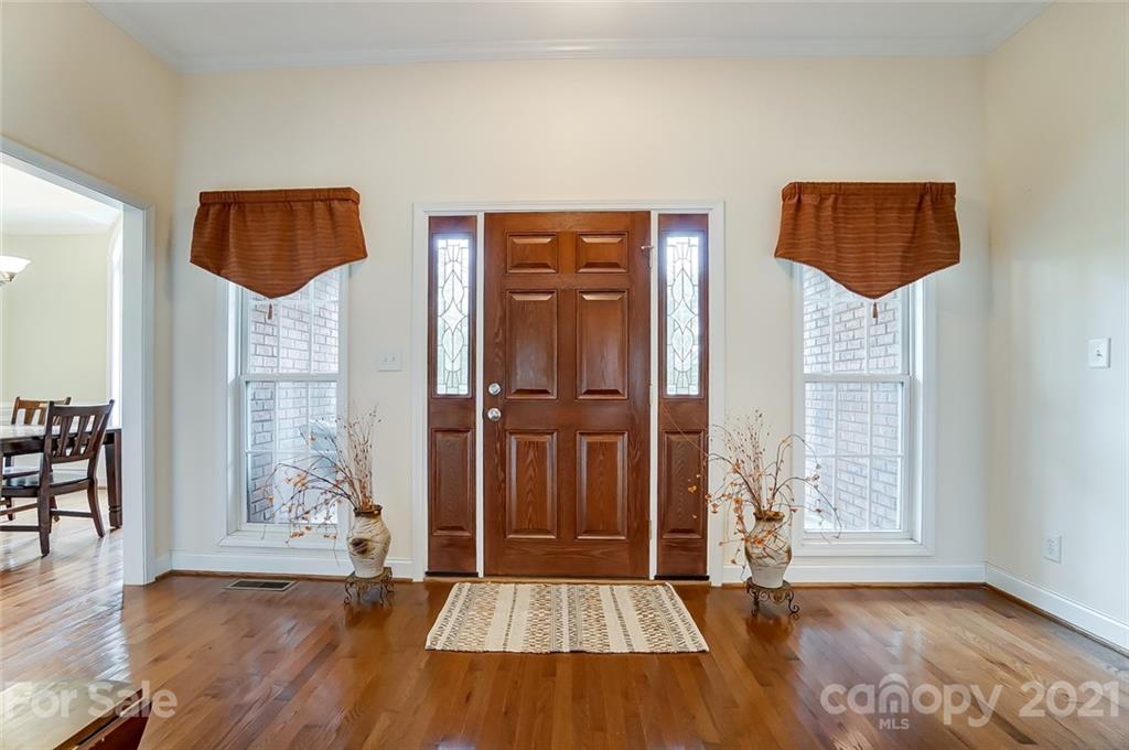 9180 Meadowood Road Mount Pleasant, NC 28124 - Photo 4 of 37 wooden floor in an empty room with a window