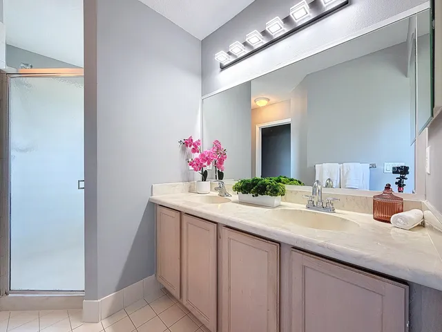a bathroom with a granite countertop sink and a mirror
