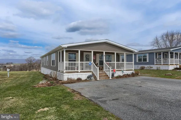 a view of a house with a yard and sitting area